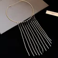 Close-up of golden waterfall tassel choker necklace with elegant metallic chains - Gold