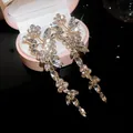 Elegant gold-finish long floral crystal drop earrings in a pink jewelry box. - Silver Post Floral Marquise Rhinestone Tassel Style (68)
