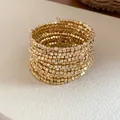 Macro detail of vintage gold multi-layer wrap bracelet with square metallic beads - Square Beads / Gold