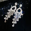 Elegant long silver-tone teardrop tassel earrings encrusted with sparkling rhinestones. - Round Diamond Water Drop Frame Tassel Style (80)