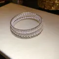 Three-layer open wrap bracelet featuring elegant white pearls and sparkling rhinestones - Four Layered Style / Silver