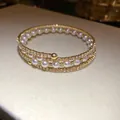 Elegant three-layer gold-plated open bracelet featuring white pearls and sparkling rhinestones - Triple Layer Style / Gold