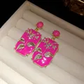 Detail of vintage court style fuchsia enamel earrings with delicate crystal flowers. - Pink (HE33630)