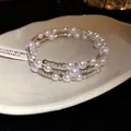 Detail of a silver-tone three-layer bracelet featuring white pearls and pavé rhinestones. - Double Layer Style / Silver