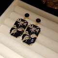 Close-up of vintage rectangular enamel earrings with floral rhinestone patterns - Black (HE33630)