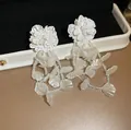 French style white floral tassel earrings featuring translucent petals and clear bead chains - Shell Embellished Style