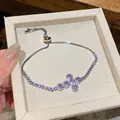 Elegante Nahaufnahme eines funkelnden Zirkon-Kreuzarmbands mit verstellbarem Gleitverschluss. - Kreuzarmband (HB5450) / Verstellbar / Rosa
