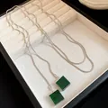 Detailed macro view of square green resin pendants on a silver snake chain necklace. - Necklace / Silver-Green