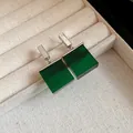 Close-up of elegant square emerald green resin earrings in a beige jewelry tray - Earrings / Silver-Green