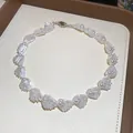 Close-up detail of an elegant pearl and white shell beaded choker collar necklace - Necklace / White