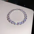 Close-up of 18k gold plated bracelet featuring sparkling purple zircons and halo detail. - Silver-Pink