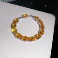 Close-up of 18k gold plated bracelet with yellow oval zircons and sparkling effect. - Silver-Yellow