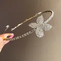 Detailed macro view of a sparkling rhinestone flower pendant on an elegant silver choker - Flower Style (HN12061) / Silver