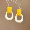 Macro detail of dopamine style yellow resin square and cream hollow hoop earrings - Silver Post Square Cutout Style / Yellow-White