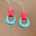 Close-up of vibrant pink and blue resin earrings in a modern geometric design - Silver Post Square Cutout Style / Pink-Blue
