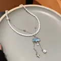 Detail of a blue cloud pendant necklace with zircon water drop and white pearls - Necklace - Silver - Blue