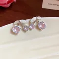 Close-up of elegant pink zircon cherry stud earrings displayed on a white ceramic tray - Cherry Shaped Stud Earrings (HE31852) / Pink