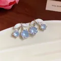 Close-up of cherry stud earrings with light blue zircons and silver textured leaves - Cherry Shaped Stud Earrings (HE31852) / Blue
