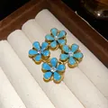 Close-up of light blue enamel flower earrings with central rhinestone in jewelry box - Double Flower Drop Style / Blue