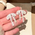 Close-up detail of sparkling silver-tone bow earrings with inlaid crystal rhinestones. - Bowknot Rhinestone Earrings (5#) / Silver
