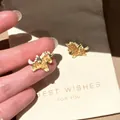 Detailed view of gold-toned unicorn stud earrings with amber glitter inlay and white stones - Unicorn Pegasus Stud Earrings (8#) / Gold Brown