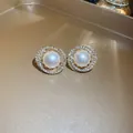 Close-up view of elegant circular pearl earrings with double rhinestone halo - Pearl Rhinestone Round Ear Clip (14#) / Gold