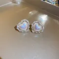 Close-up detail of Korean heart-shaped stud earrings with sparkling stones and iridescent core - Minimalist Iridescent Heart Ear Clip (15#) / Gold