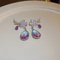 Close-up detail of elegant flower earrings with purple and blue gradient pear-shaped drops. - Gradient Teardrop Zirconia Dangle Earrings (24#) / Purple