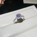 Macro view of a silver ring with a round purple zircon stone set in a white jewelry box. - Open Adjustable Ring / Silver Band-Purple Zirconia