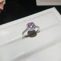 Close-up detail of a silver zircon ring featuring a sparkling pink round center stone - Open Adjustable Ring / Silver Band-Pink Zirconia