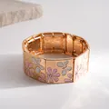 Detailed view of the enamel butterfly patterns and gold-toned plating on this vintage bracelet. - Gold-Pink-White