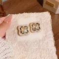 Close-up of gold-plated flower stud earrings with champagne crystals and pavé diamonds. - Silver Post Coffee Main Stone / Gold