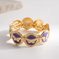 Macro view of vintage gold elastic bracelet with purple butterfly oil-drip medallions - Gold Purple Butterfly
