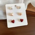 Set of three heart-shaped stud earrings in pearl white, champagne, and red colors - 6 Pairs Set / Multicolor Heart