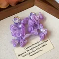Close-up detail of handmade purple chiffon flower earrings with delicate beadwork - Purple