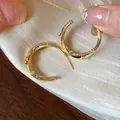 Elegant 18k gold plated C-shaped earrings featuring sparkly zircon stones details - Gold