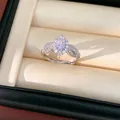 Exquisite silver-tone ring with a central pink oval gemstone and sparkling leaf details - Silver