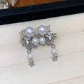 Detailed close-up of Korean style star pearl ear clips with zircon accents in jewelry box. - Ear Cuff (Pair) / Silver