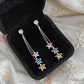 Detail view of long tassel earrings with colorful star-shaped zircons in a box. - Star Style (HE32882) / Silver