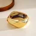 Macro view of premium metallic gold chunky geometric hinged bangle bracelet for women - Gold