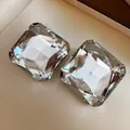 Macro view of square clear crystal stud earrings with elegant multifaceted facets - Clear