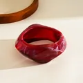 Macro view of deep red marbled resin bracelet with irregular geometric design - Burgundy