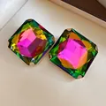 Detailed view of square stud earrings with faceted iridescent rainbow stones - Colorful