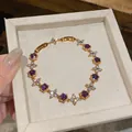 Exquisite close-up of 18k gold plated bracelet featuring purple and white zircon stones - Flower Style (HB5804) / Gold-Purple