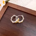 Detailed close-up of sweet floral hoop earrings with yellow enamel daisy patterns. - Ear Buckle / Yellow