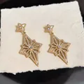 Exquisite diamond-studded rhombic star earrings in premium gold finish with cubic zirconia - Gold