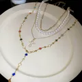 Detailed view of multi-layer necklace with pearls, cross pendant and colorful beads - Colorful / Gold