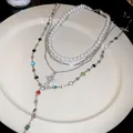 Detail of multi-layer necklace with resin pearls, colorful stones, and a cross pendant - Colorful / Silver