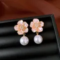 Detailed close-up of pink enamel flower earrings featuring elegant large white pearl drops - Flower Pearl Drop Style / Pink