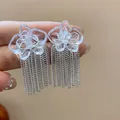 Detailed macro view of transparent resin flower earrings with silver chain tassels - Metal Chain Tassel Style (1#) / Silver